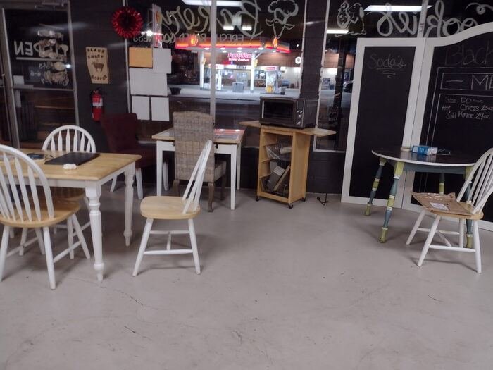 Evening seating area at Black Sheep Coffee with soda chalkboard menu